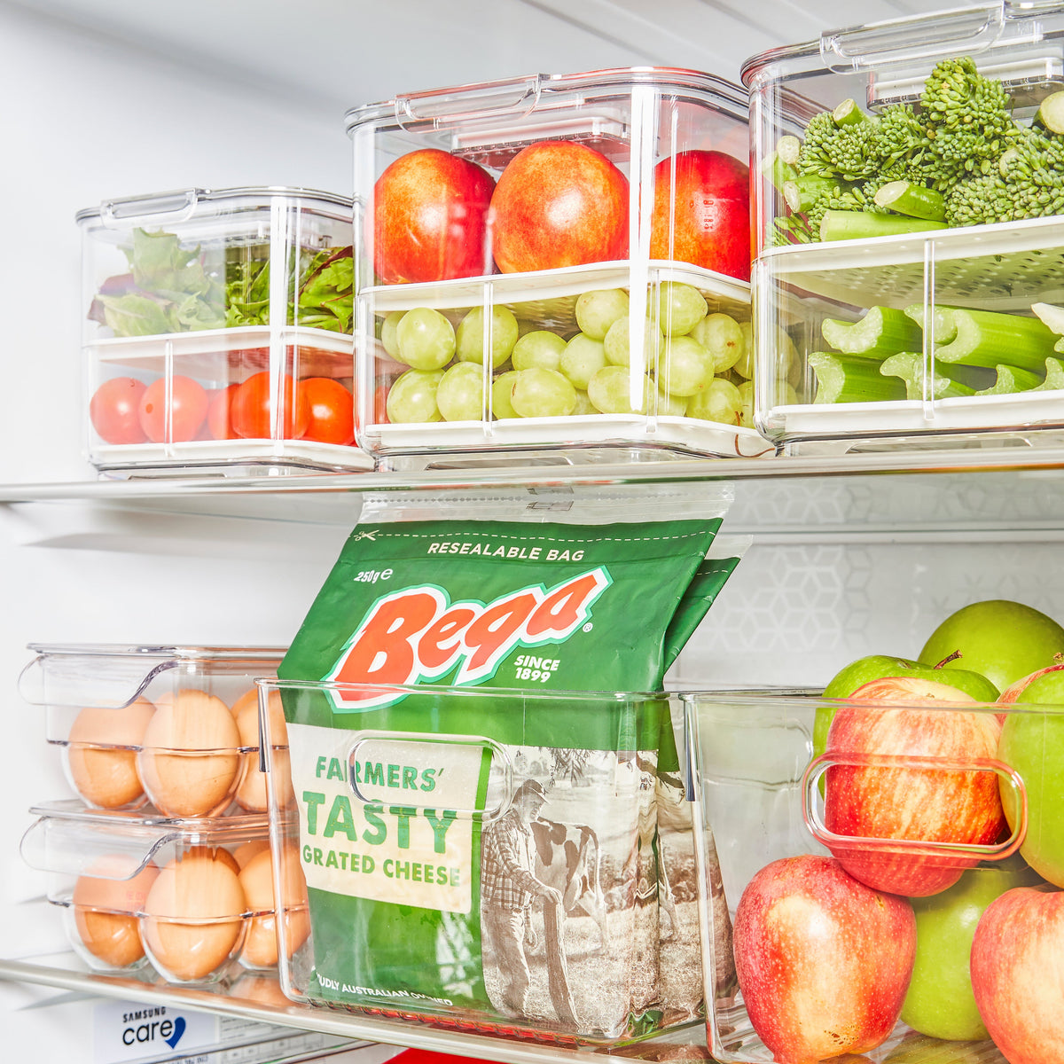 A complete fridge storage container set perfectly organising fresh produce and snacks on refrigerator shelves.