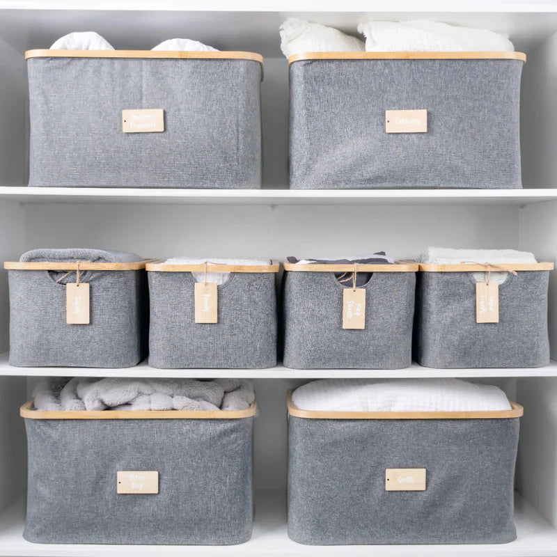 An 8-piece grey linen storage set on a white closet shelf.