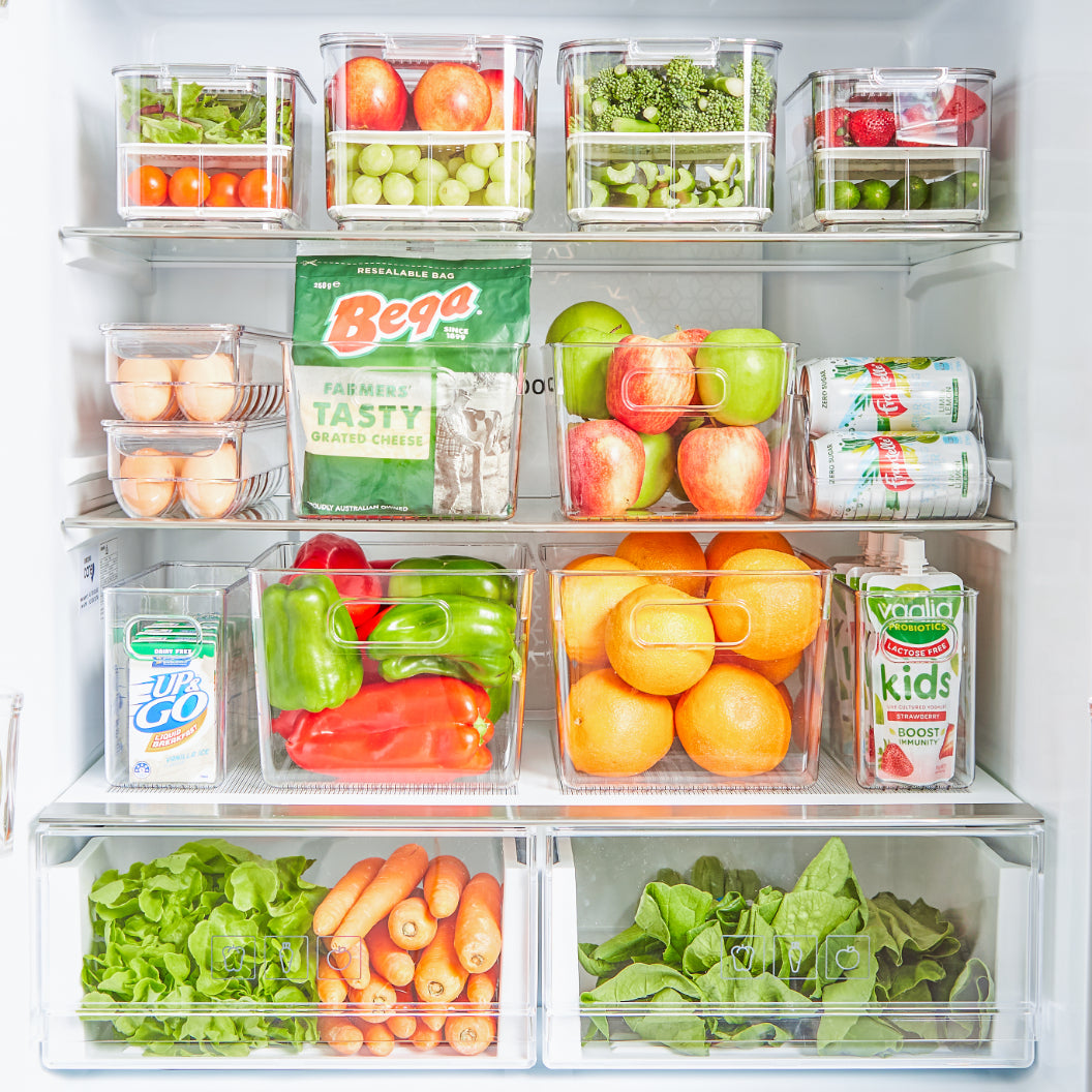 Clear fridge storage containers and fresh keepers perfectly organising fruit and vegetables inside a refrigerator.