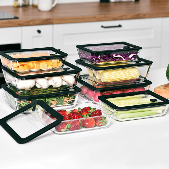 Stacked glass meal prep containers filled with fresh food